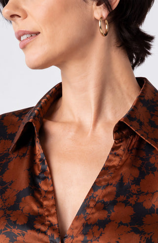 Close view of neckline and floral stretch satin on Liverpool black copper blouse