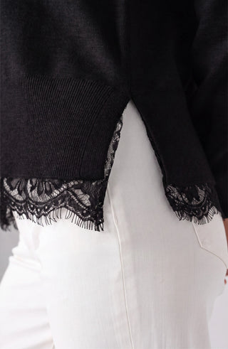 Close view of lace trim and side slit on Liverpool black sweater