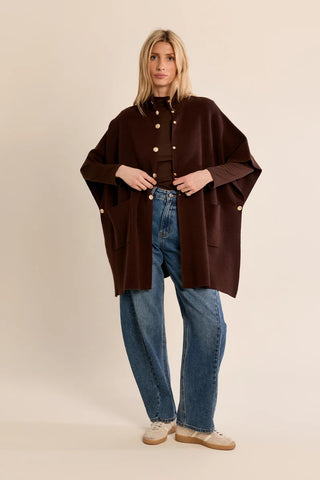 Molly Bracken brown knit cape worn open with jeans