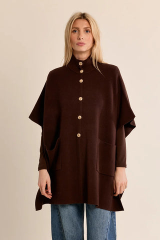 Front view of brown Molly Bracken knit cape with metal snaps and patch pockets